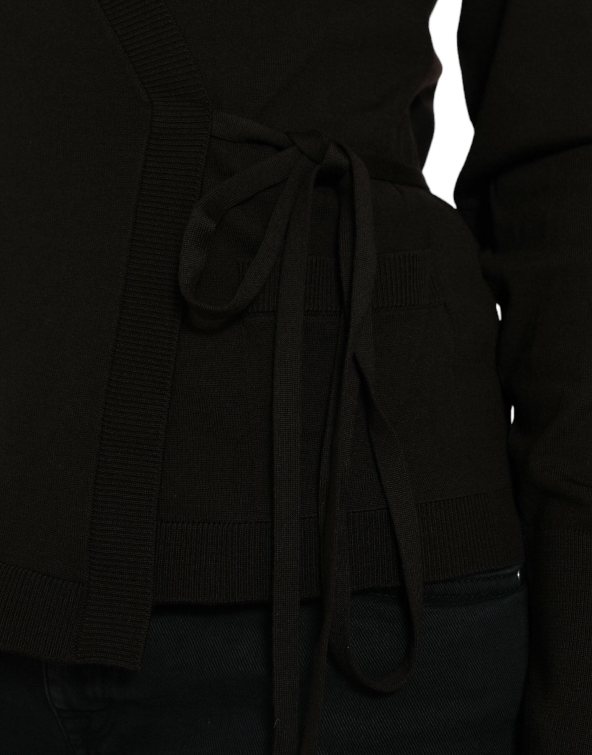Black wool V-neck crossed cardigan sweater by Dolce & Gabbana with long sleeves and button closure, displayed on a neutral background.