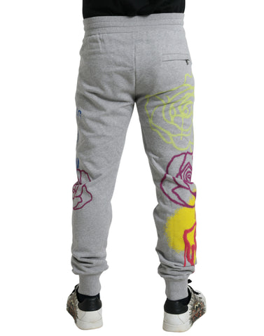 Gray cotton graffiti jogger pants by Dolce & Gabbana with relaxed fit and stylish graffiti print, casual streetwear style.