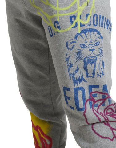 Gray cotton graffiti jogger pants by Dolce & Gabbana, featuring relaxed fit and stylish graffiti print on soft fabric.