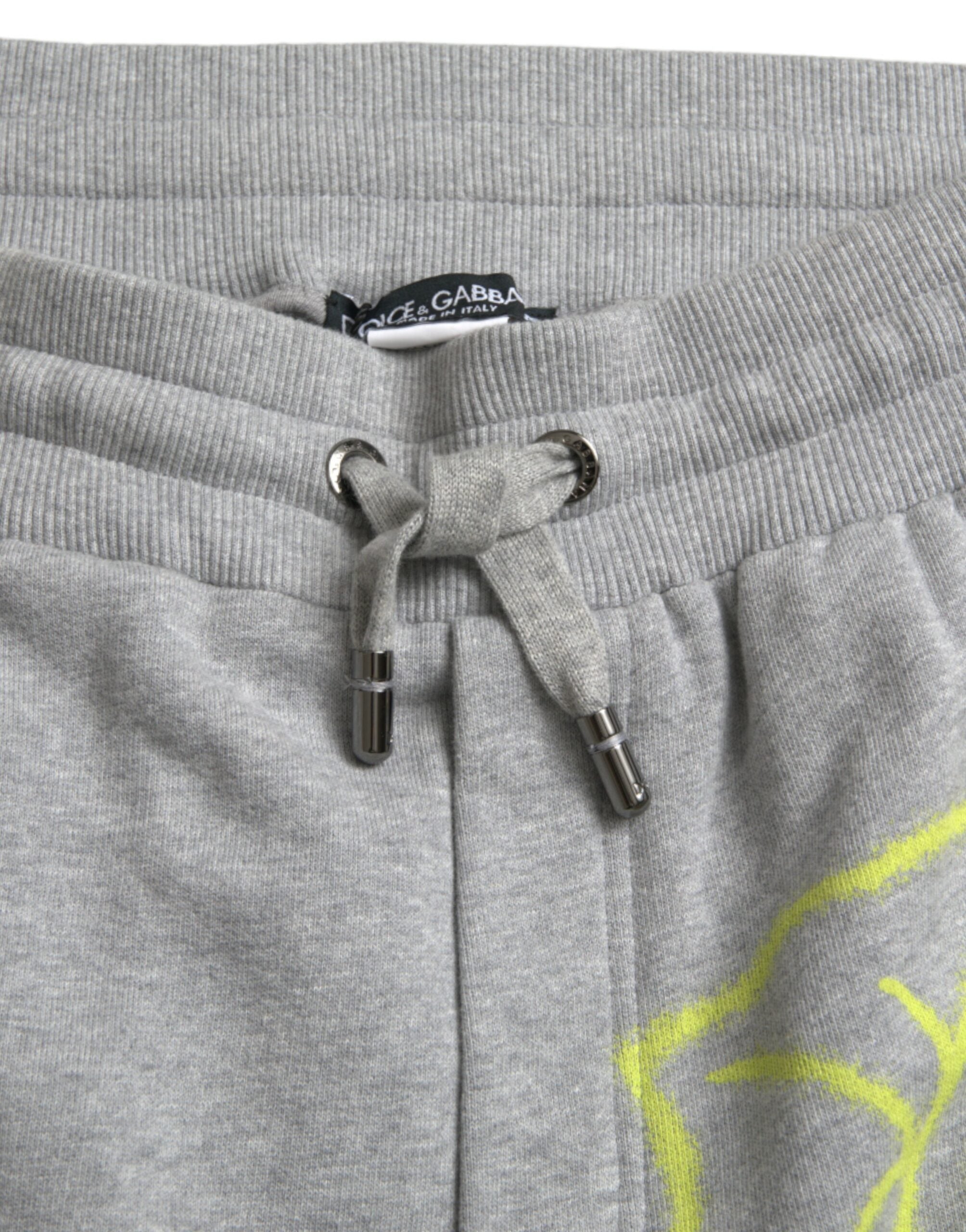 Gray cotton graffiti sweatpants by Dolce & Gabbana, featuring relaxed jogger style with artistic graffiti print.