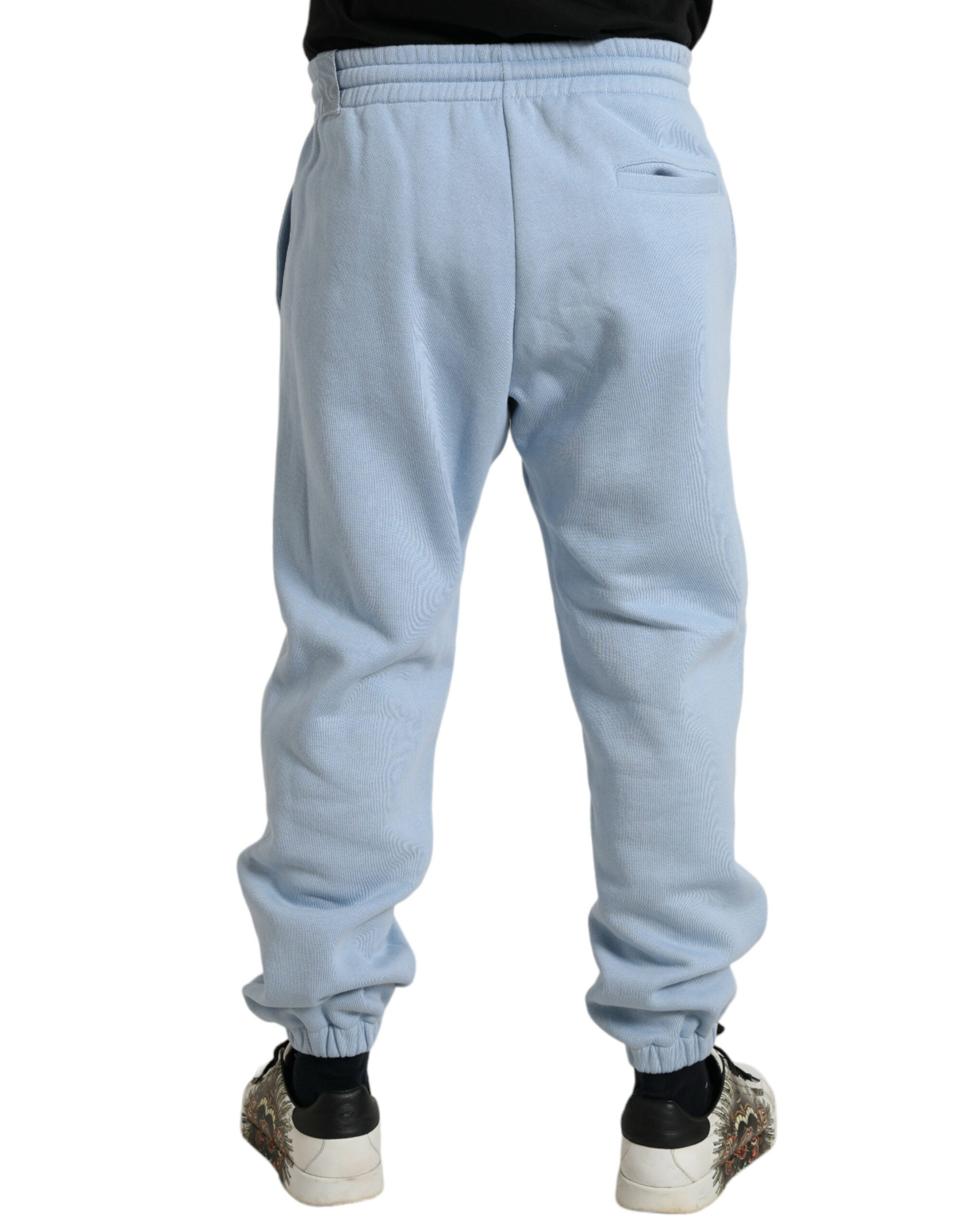 Light blue cotton sweatpants for men by Dolce & Gabbana, featuring jogger style with elastic waistband and tapered fit.