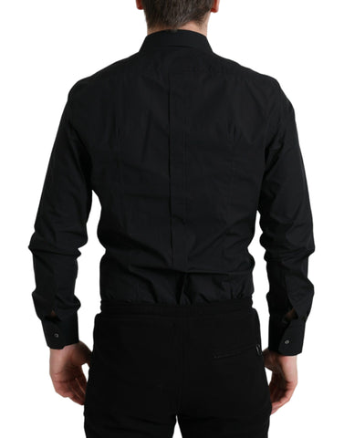 Black cotton men's formal dress shirt with gold accents by Dolce & Gabbana, shown on a hanger.