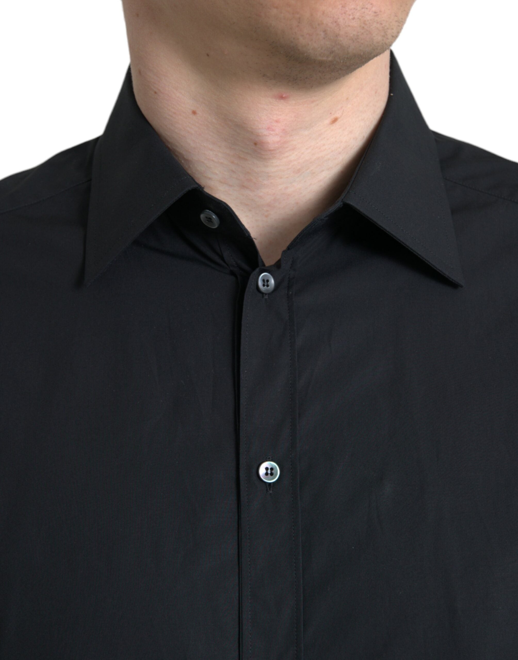Black cotton men's formal dress shirt by Dolce & Gabbana with gold accents, shown laid flat on a white background.