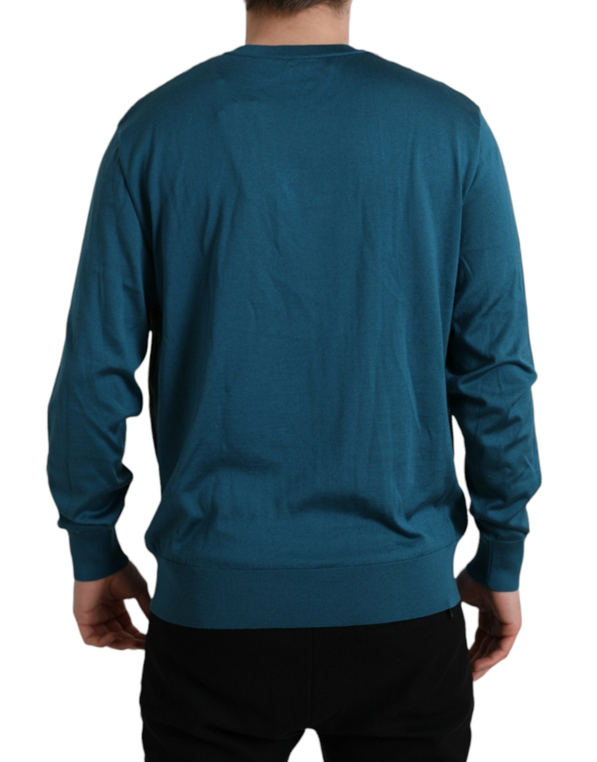 Green peacock feather Dolce & Gabbana pullover sweater showing intricate feather pattern and cozy knit fabric.