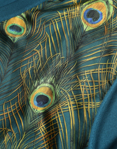 Green peacock feather Dolce & Gabbana pullover sweater showing intricate feather pattern and cozy knit fabric.