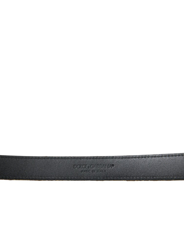 Gold leather Jacquard belt with silver metal buckle from Dolce & Gabbana, featuring intricate woven pattern and adjustable strap.