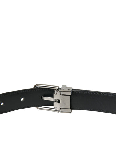 Black leather belt with silver metal buckle from Dolce & Gabbana, featuring a sleek and stylish design.
