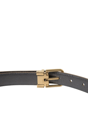 Dolce & Gabbana metallic gold calf leather belt with a metal buckle, showcasing a stylish and luxurious accessory.