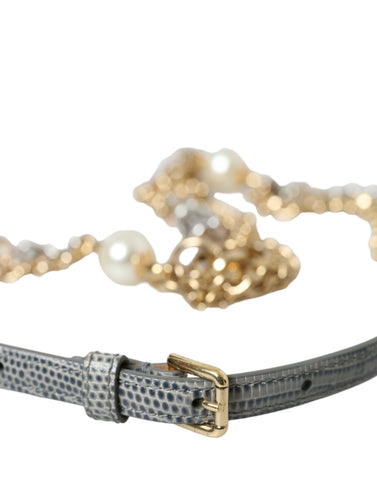 Blue braided gold brass chain waist belt with Dolce & Gabbana logo details on a neutral background.