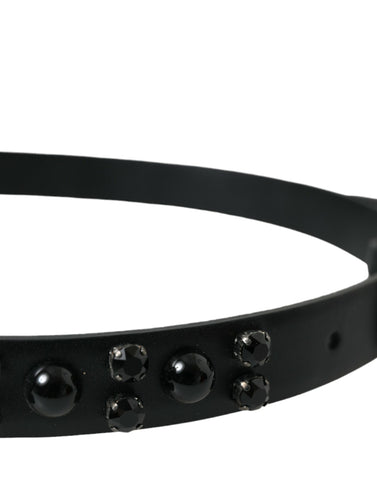 Black leather belt with engraved buckle and embellishments from Dolce & Gabbana, featuring detailed craftsmanship and stylish design.