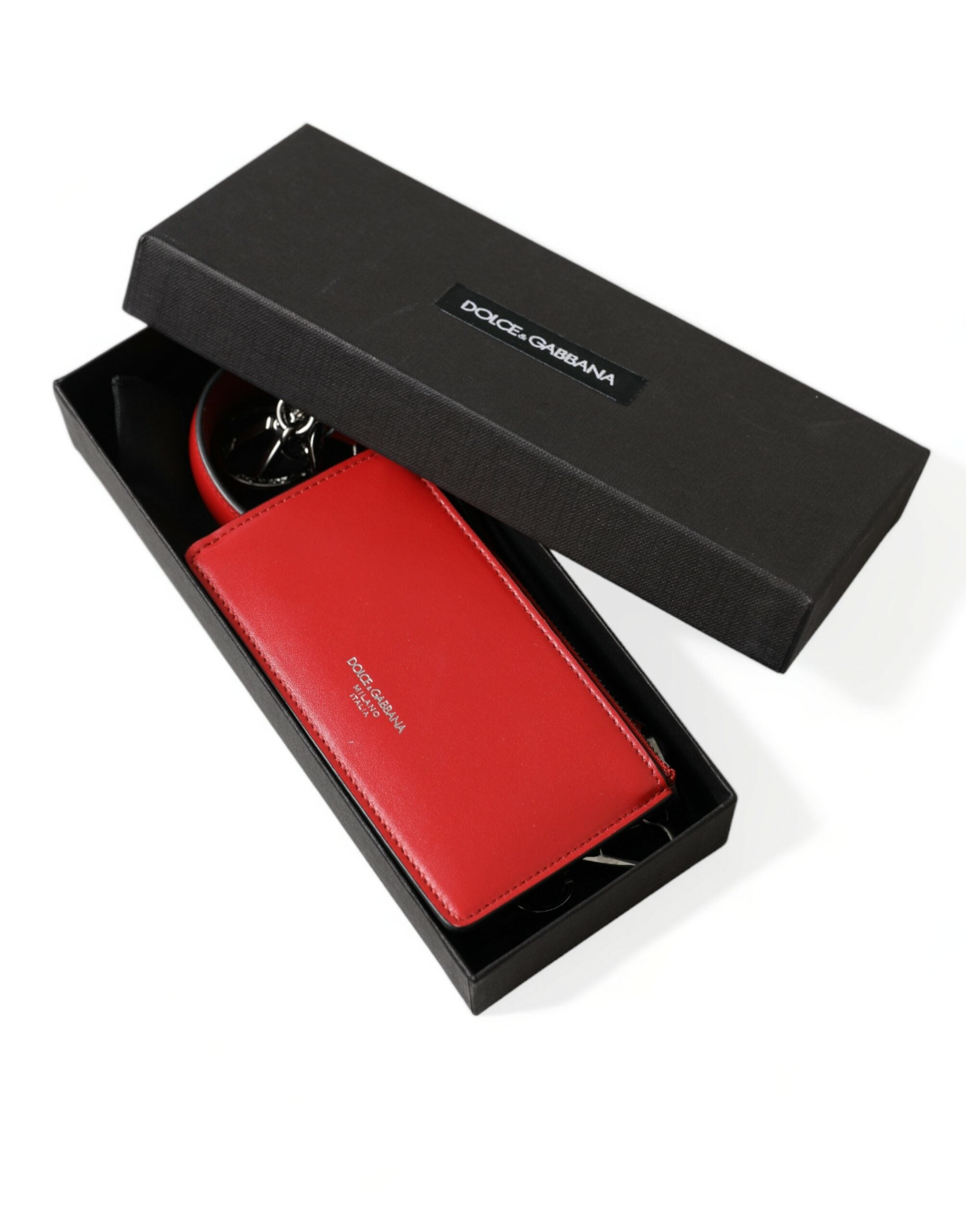 Red leather AirPods case with silver metal logo strap pouch by Dolce & Gabbana, featuring a sleek and stylish design.
