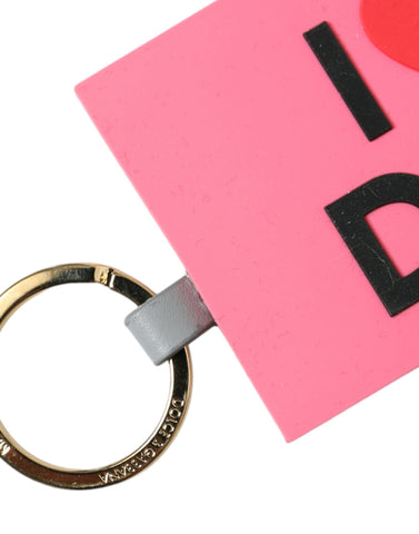 Pink silicone Dolce & Gabbana logo keychain with gold brass accents, featuring the iconic DG branding and a sleek, stylish design.