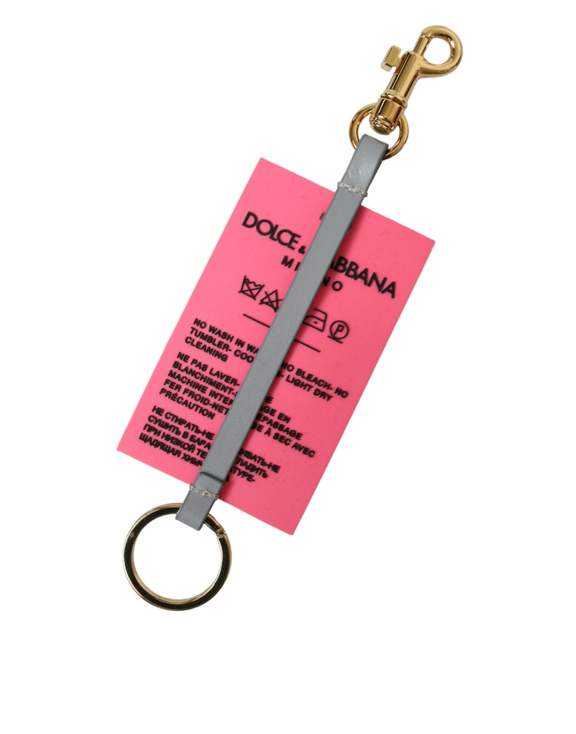 Pink silicone Dolce & Gabbana keychain with gold brass DG logo and branding details.