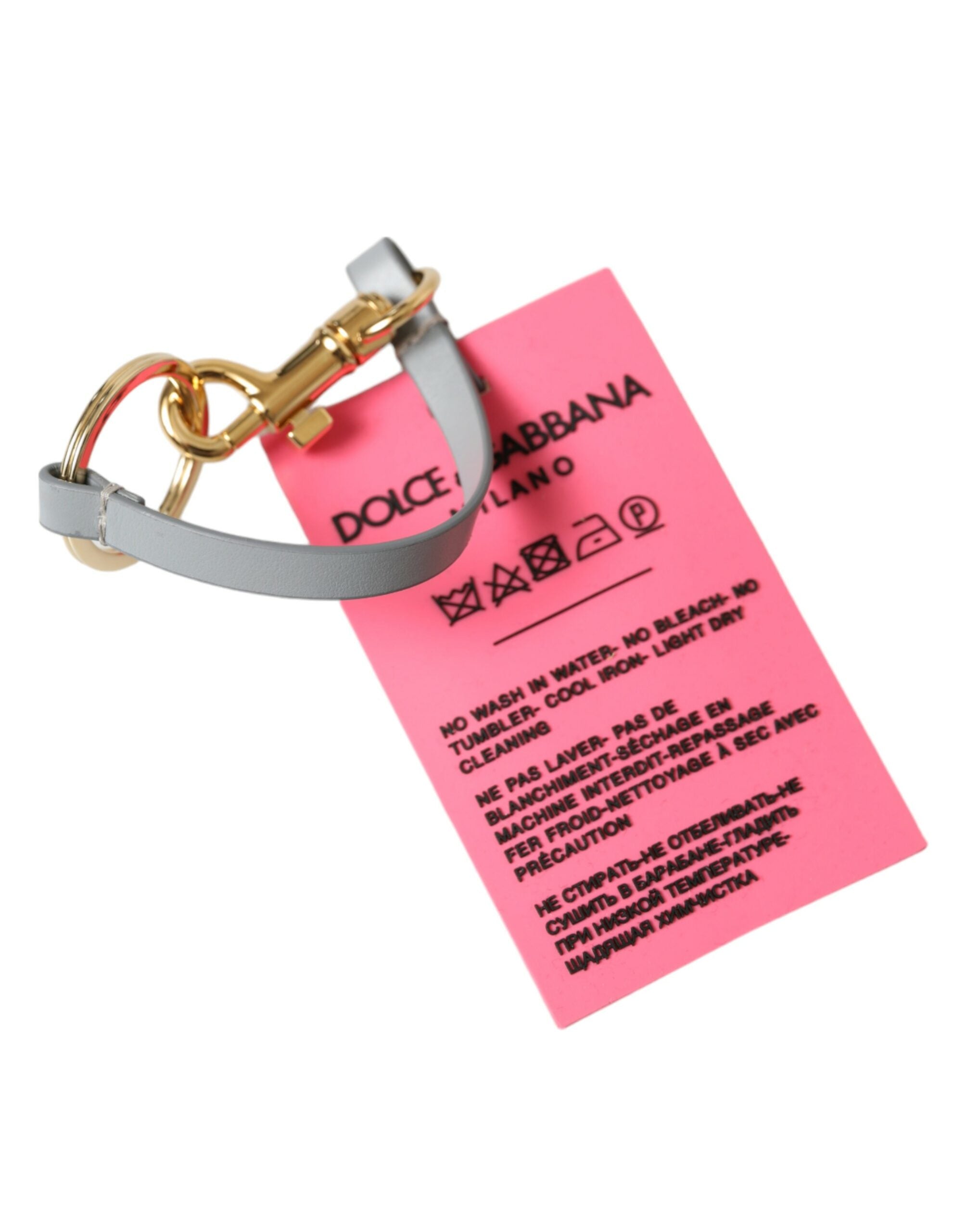 Pink silicone keychain with gold brass Dolce & Gabbana DG logo, featuring a stylish and lightweight design.