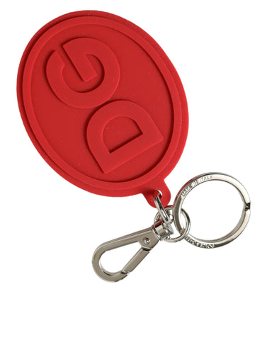 Red rubber Dolce & Gabbana keyring with silver brass DG logo, featuring a durable metal keychain design.