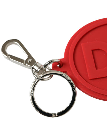 Red rubber Dolce & Gabbana keyring with silver brass DG logo, featuring a stylish and durable keychain design.