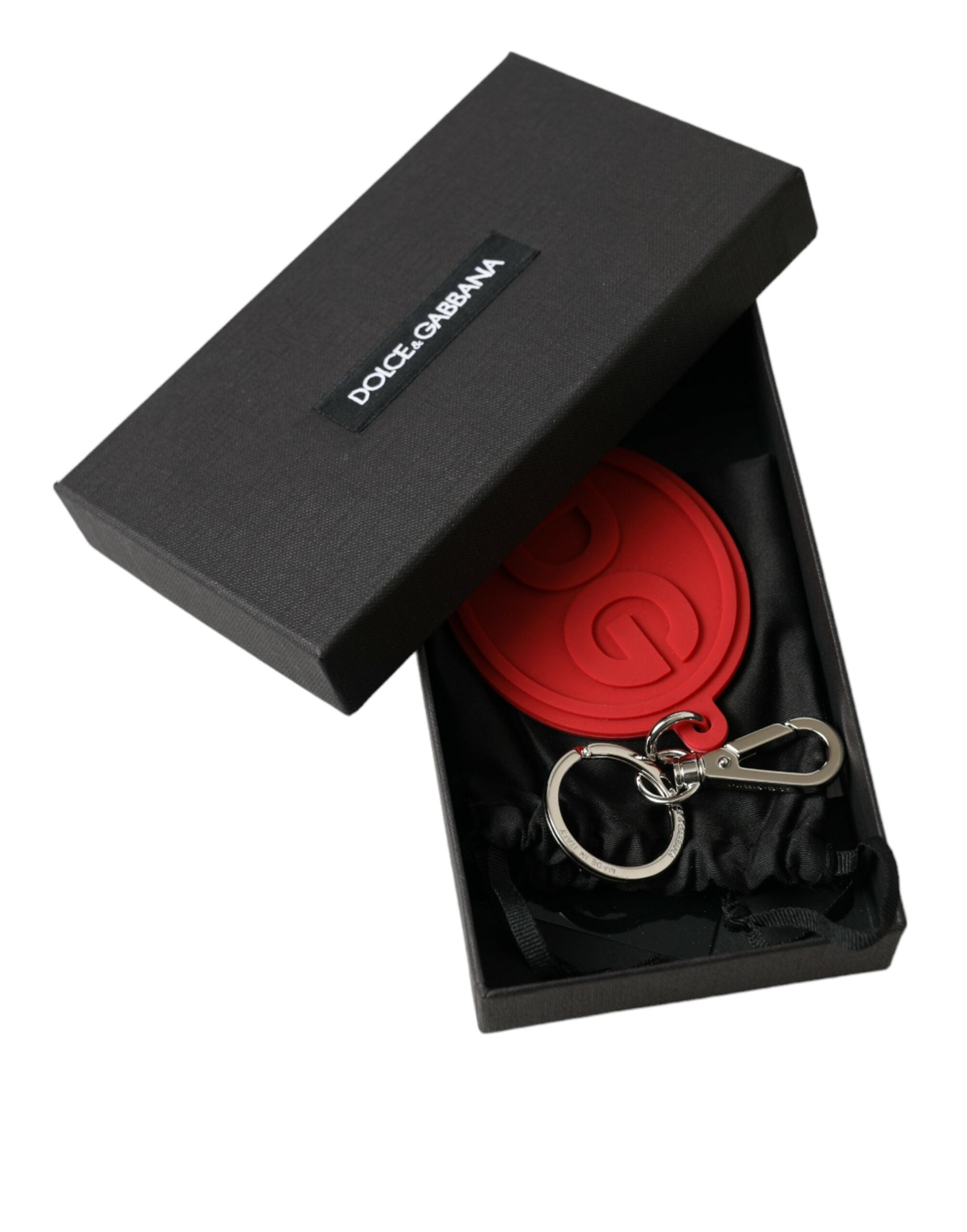 Red rubber Dolce & Gabbana logo keyring with silver brass metal keychain attachment and DG branding details.
