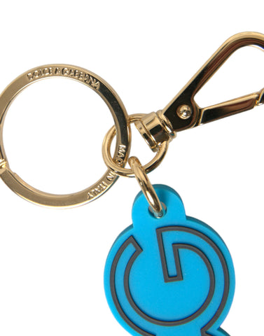 Blue rubber Dolce & Gabbana gold-tone metal logo keyring with DG branding and keychain attachment.