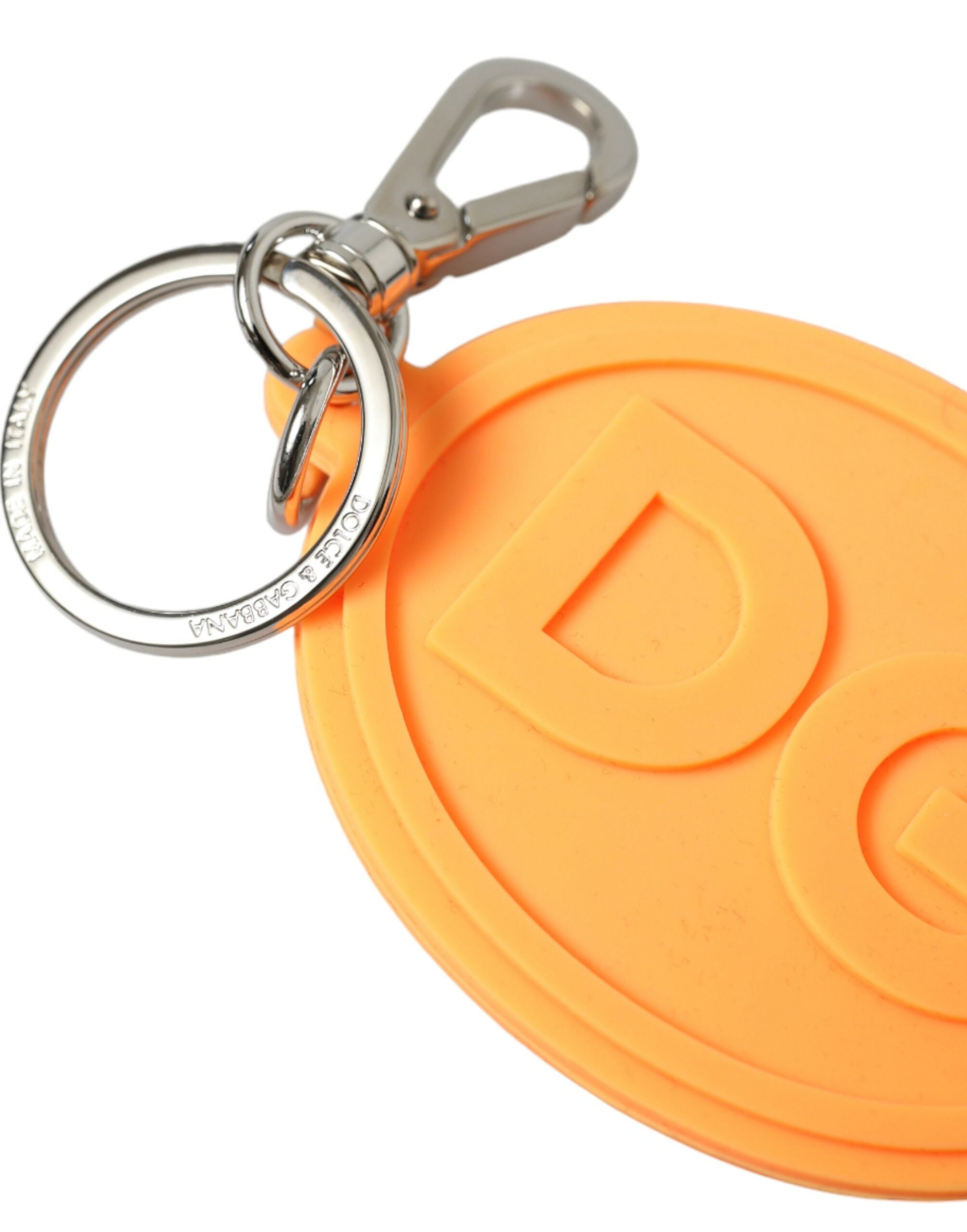 Orange rubber keyring with Dolce & Gabbana DG logo and silver brass metal keychain attached.