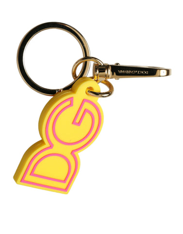 Yellow rubber and gold-tone metal Dolce & Gabbana logo keyring with engraved DG branding on a keychain.