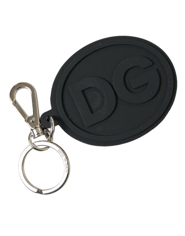 Black rubber Dolce & Gabbana keyring with silver brass DG logo, featuring a metal keychain and stylish design.