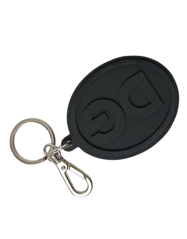 Black rubber Dolce & Gabbana keyring with silver brass DG logo, featuring a durable metal keychain attachment.