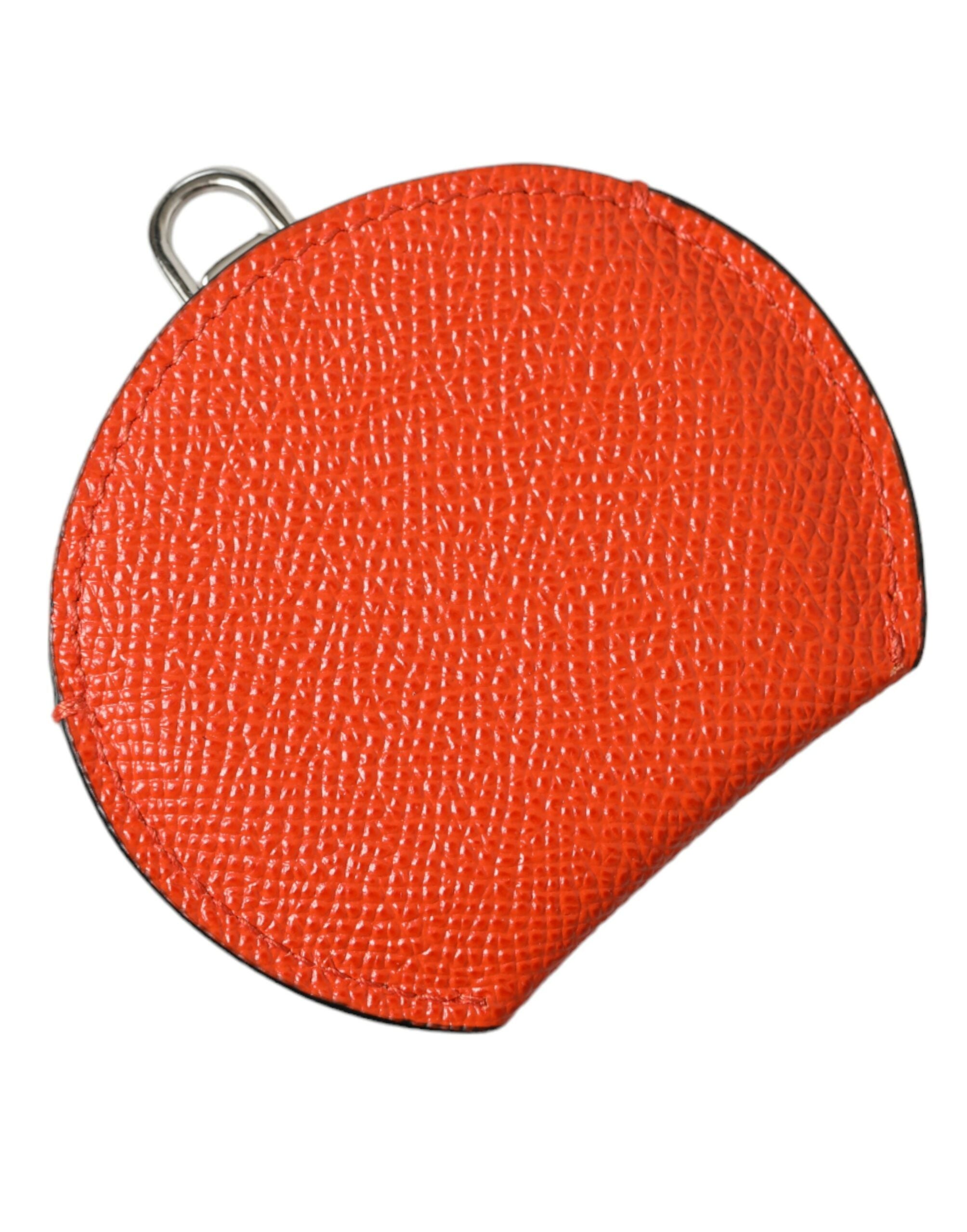 Orange calfskin leather round logo hand mirror holder by Dolce & Gabbana with embossed logo detail.
