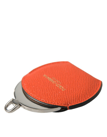 Orange calfskin leather round logo hand mirror holder by Dolce & Gabbana displaying textured leather and logo detailing.