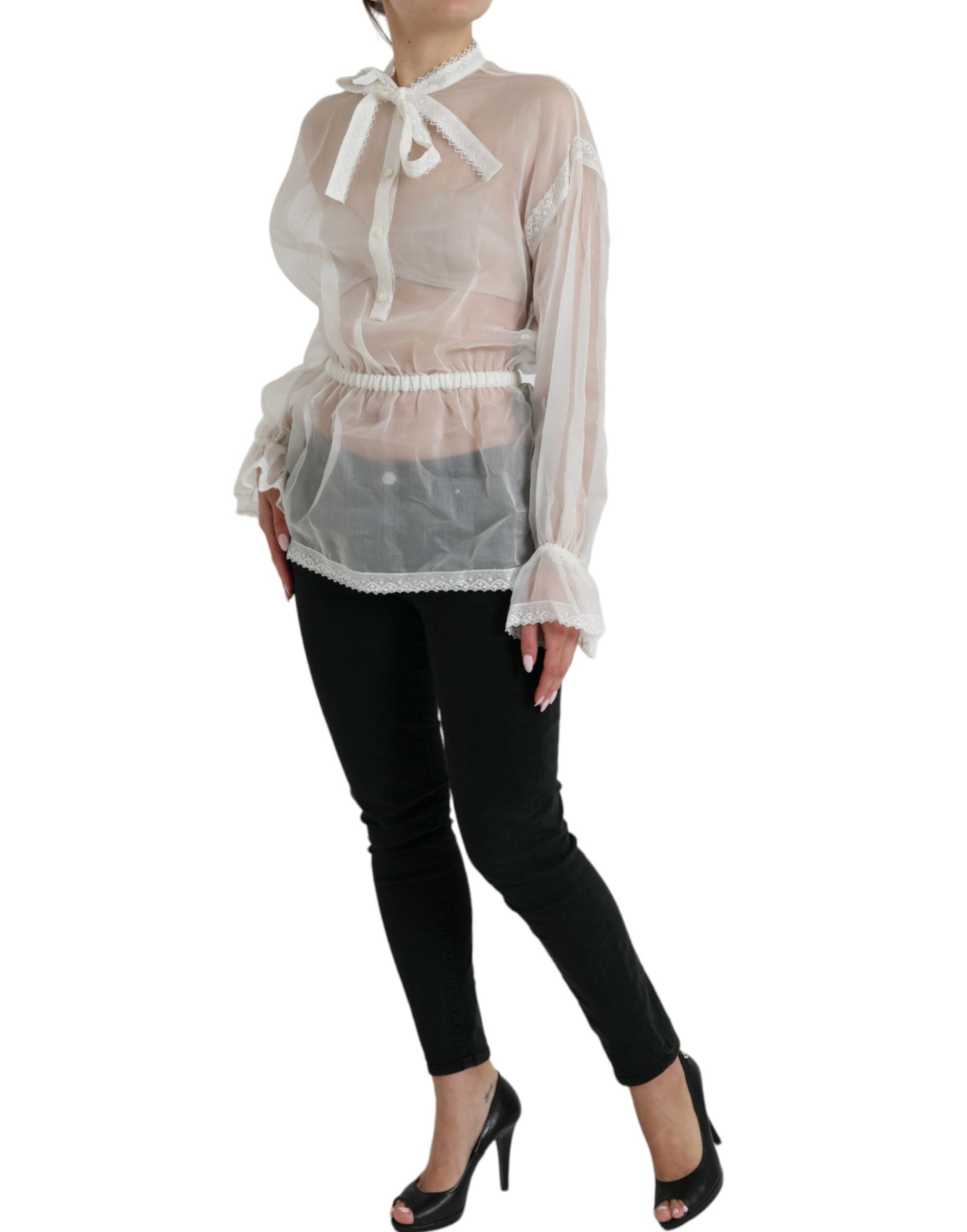 White silk long-sleeve top with ascot collar by Dolce & Gabbana, featuring elegant, smooth fabric and a sophisticated design.
