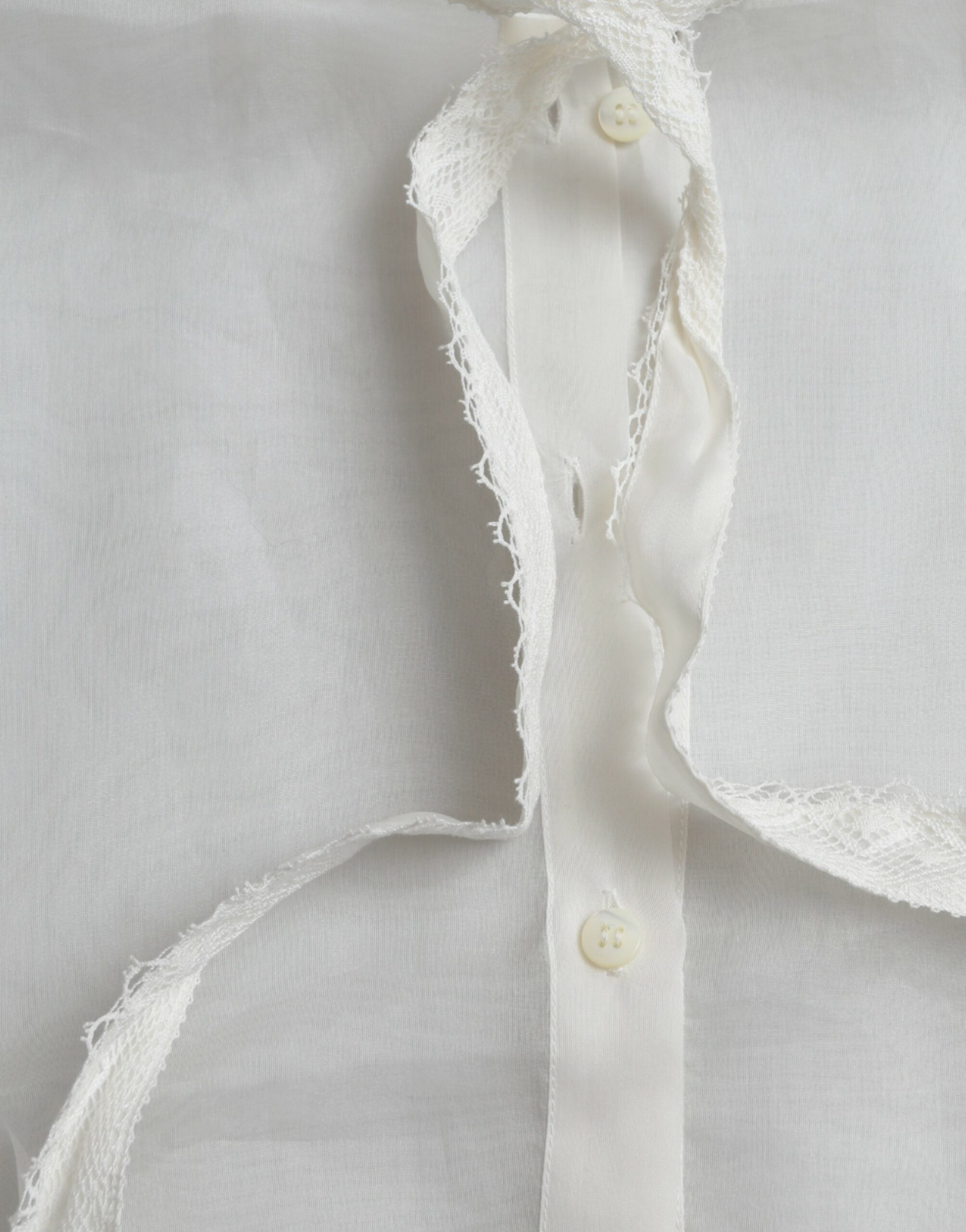White silk long sleeve top with ascot collar by Dolce & Gabbana, featuring elegant fabric and classic design.