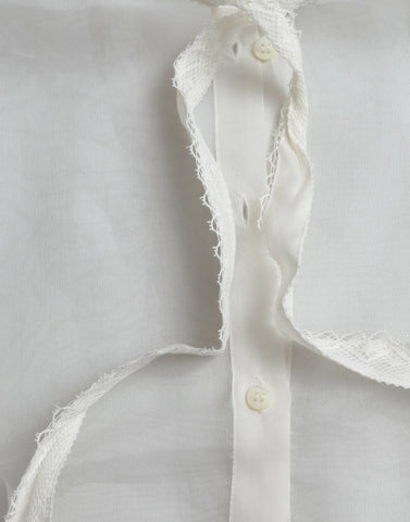 White silk long sleeve top with ascot collar by Dolce & Gabbana, featuring elegant fabric and classic design.