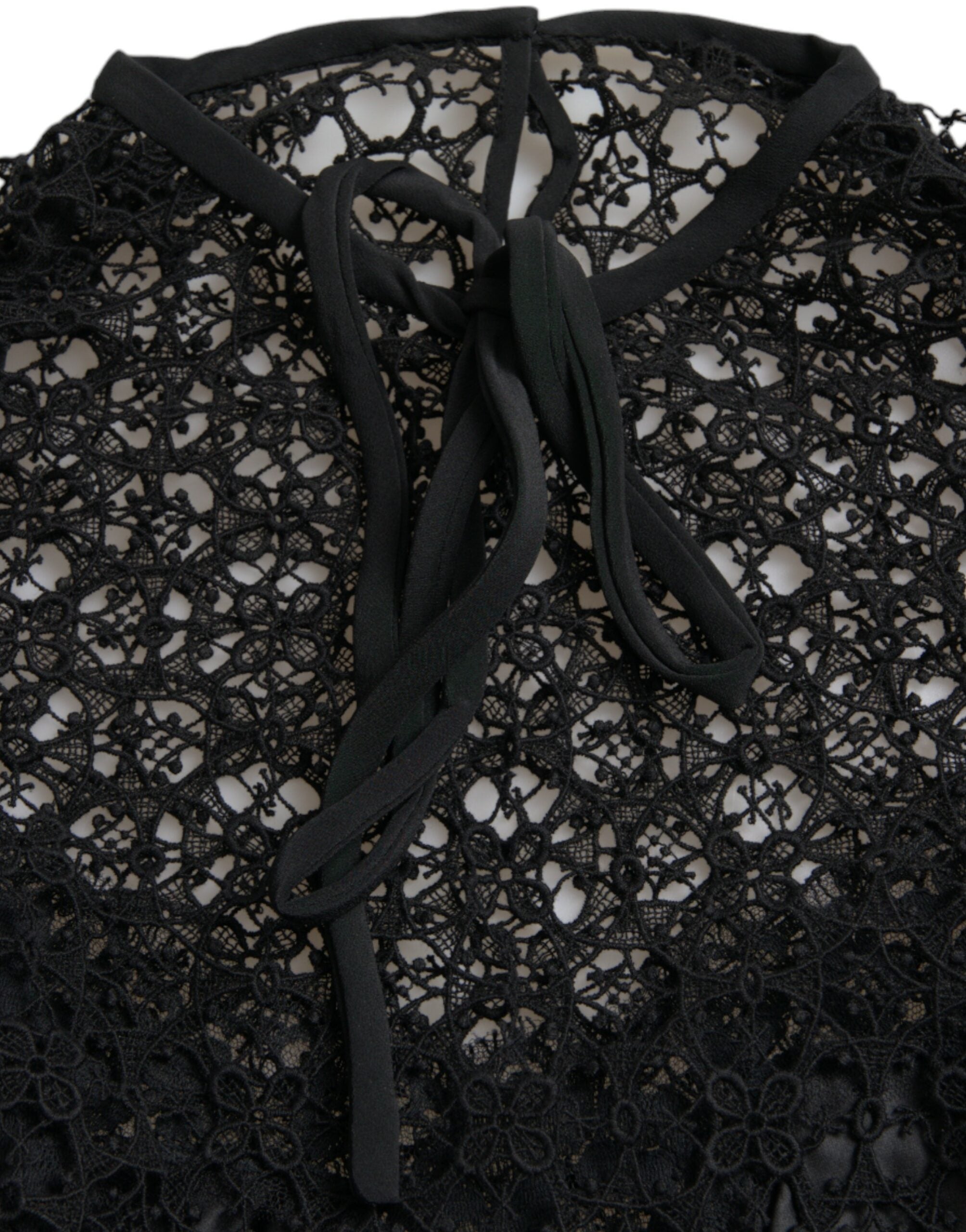 Black floral lace short-sleeve blouse top by Dolce & Gabbana, featuring delicate lace fabric and elegant short sleeves.