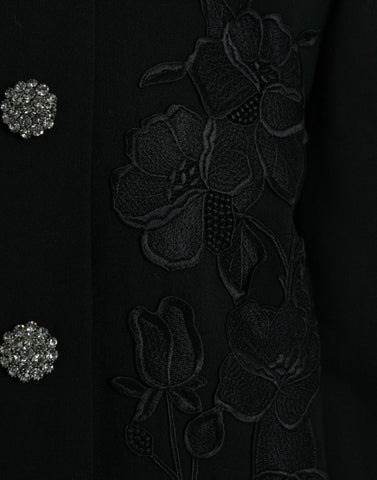 Black floral wool jacket with button embellishments from Dolce & Gabbana, featuring a tailored fit and intricate floral patterns.