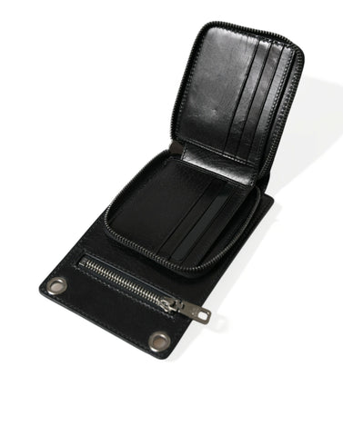 Black leather Dolce & Gabbana wallet with zip closure, logo detail, crossbody strap, and phone slot for convenient carrying.