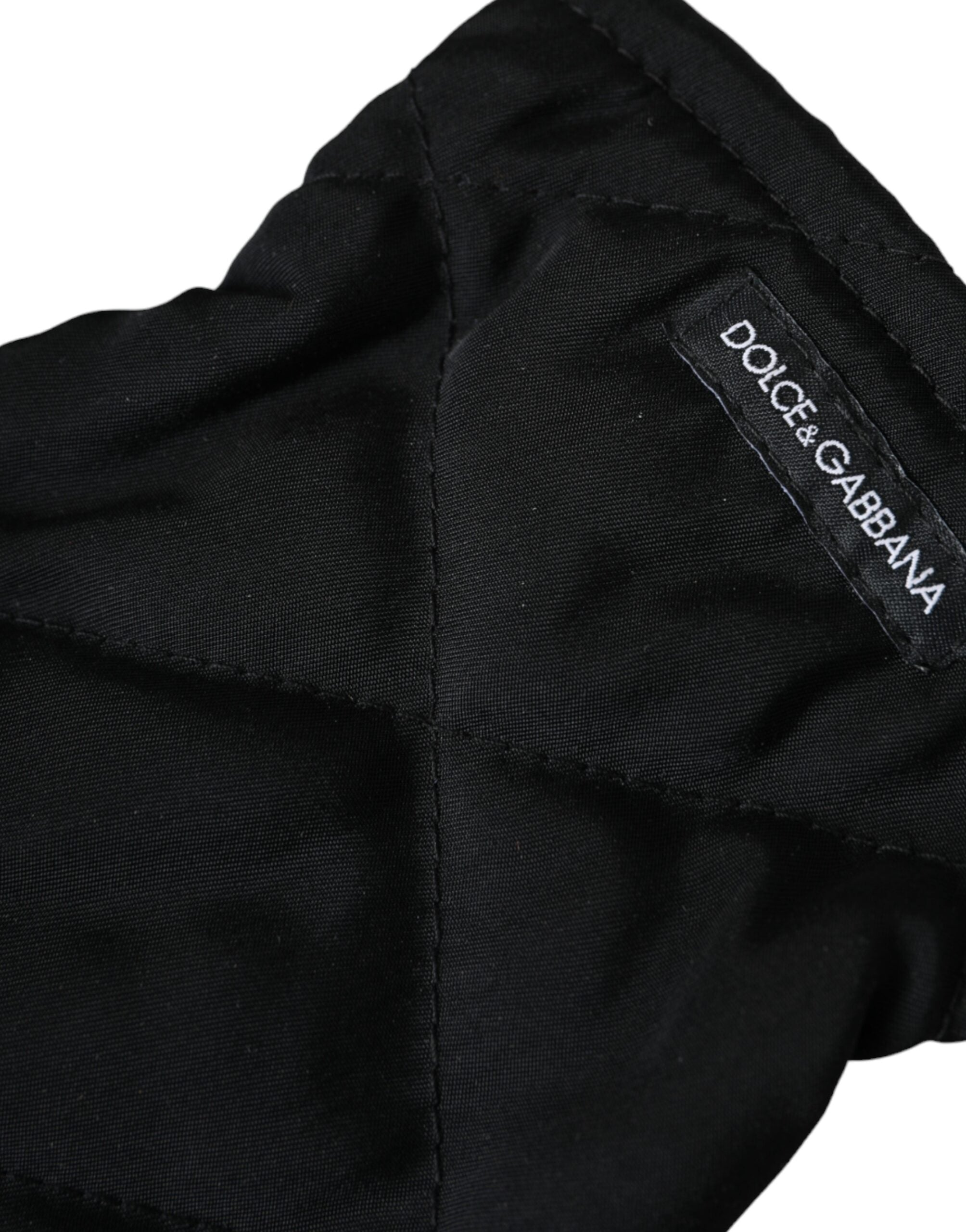 Black quilted nylon wrist-length mitten gloves by Dolce & Gabbana, showing the padded quilted design and snug fit.