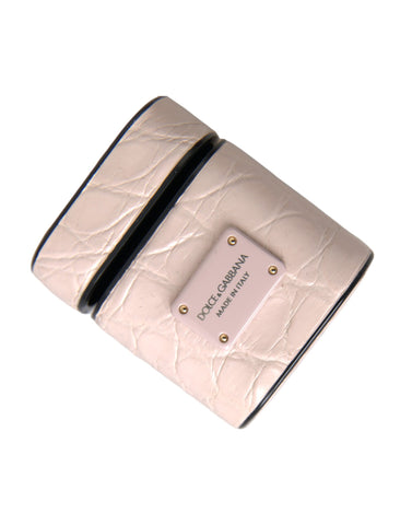 Light pink leather AirPods case with metal Dolce & Gabbana logo plaque, stylish protective accessory for wireless earbuds.