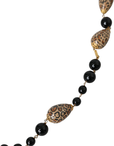 Gold tone brass long chain necklace with black printed beads from Dolce & Gabbana, featuring an elegant beaded design.