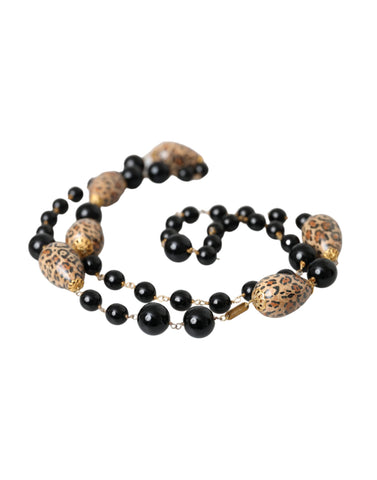 Gold tone brass long chain necklace with black printed beads from Dolce & Gabbana, showcasing intricate bead design and elegant style.
