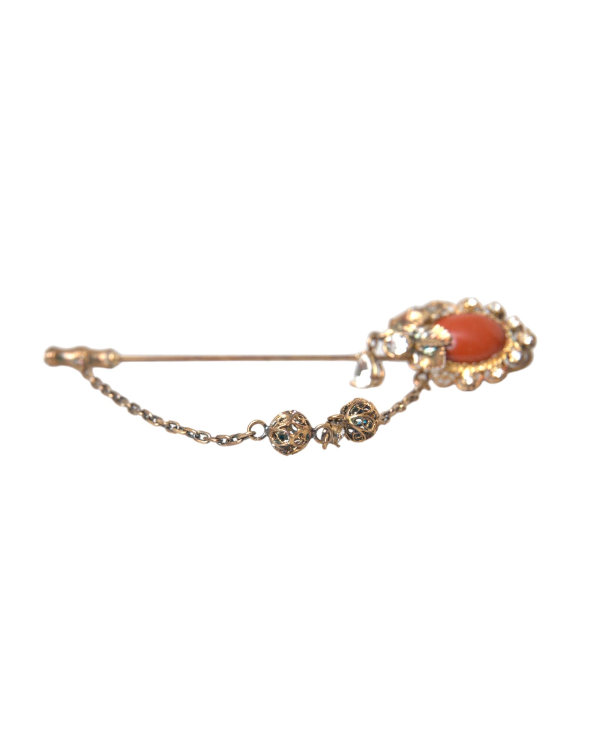 Gold brass and crystal chain with a 925 sterling silver pin brooch from Dolce & Gabbana, featuring intricate design details.
