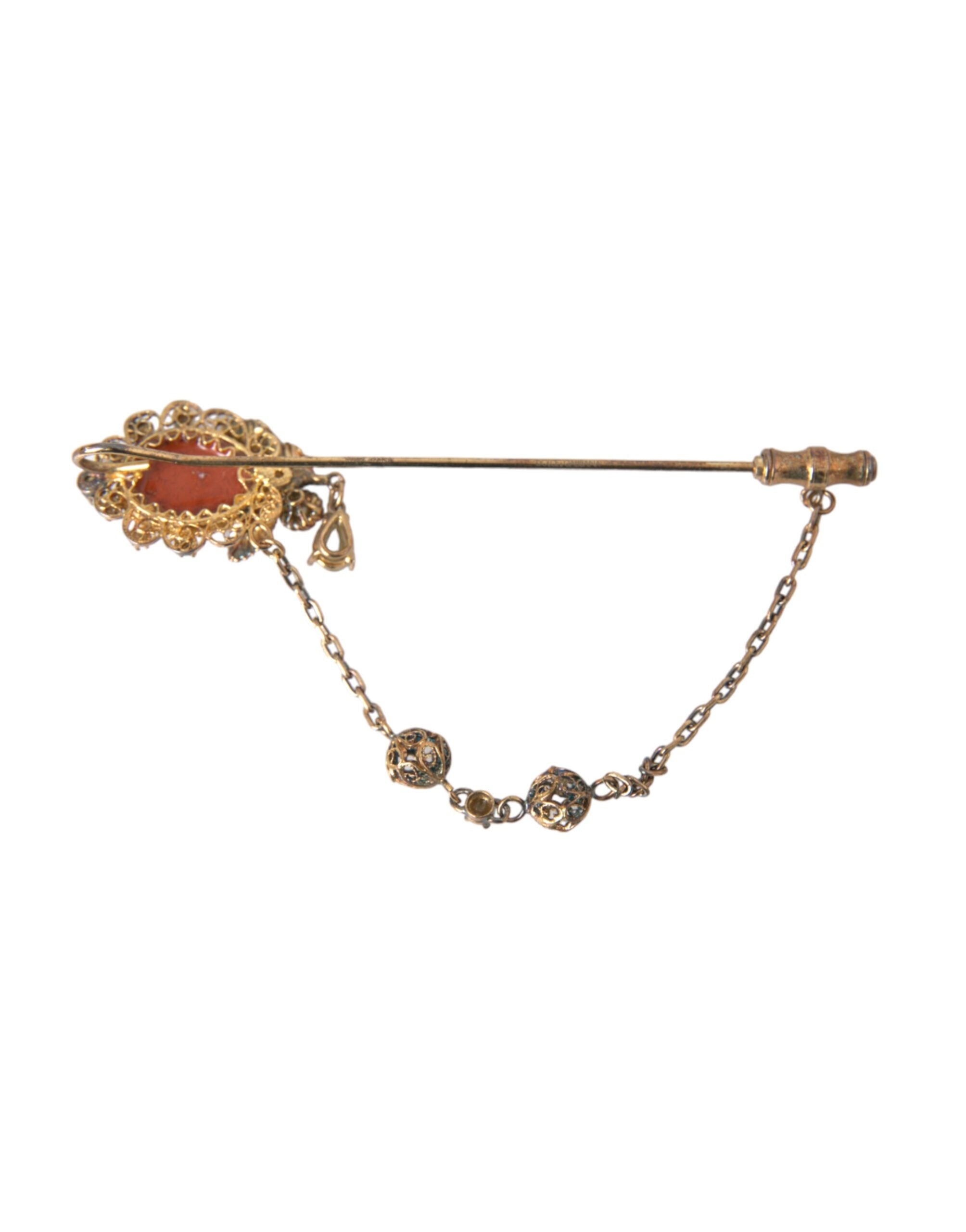 Gold brass crystal chain with a 925 sterling silver pin brooch, featuring Dolce & Gabbana branding and intricate gemstone details.