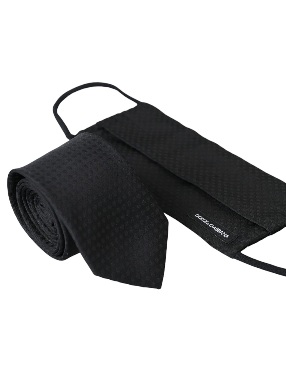 Black 100% silk adjustable necktie face mask by Dolce & Gabbana, featuring a smooth silk fabric and adjustable strap for comfortable fit.