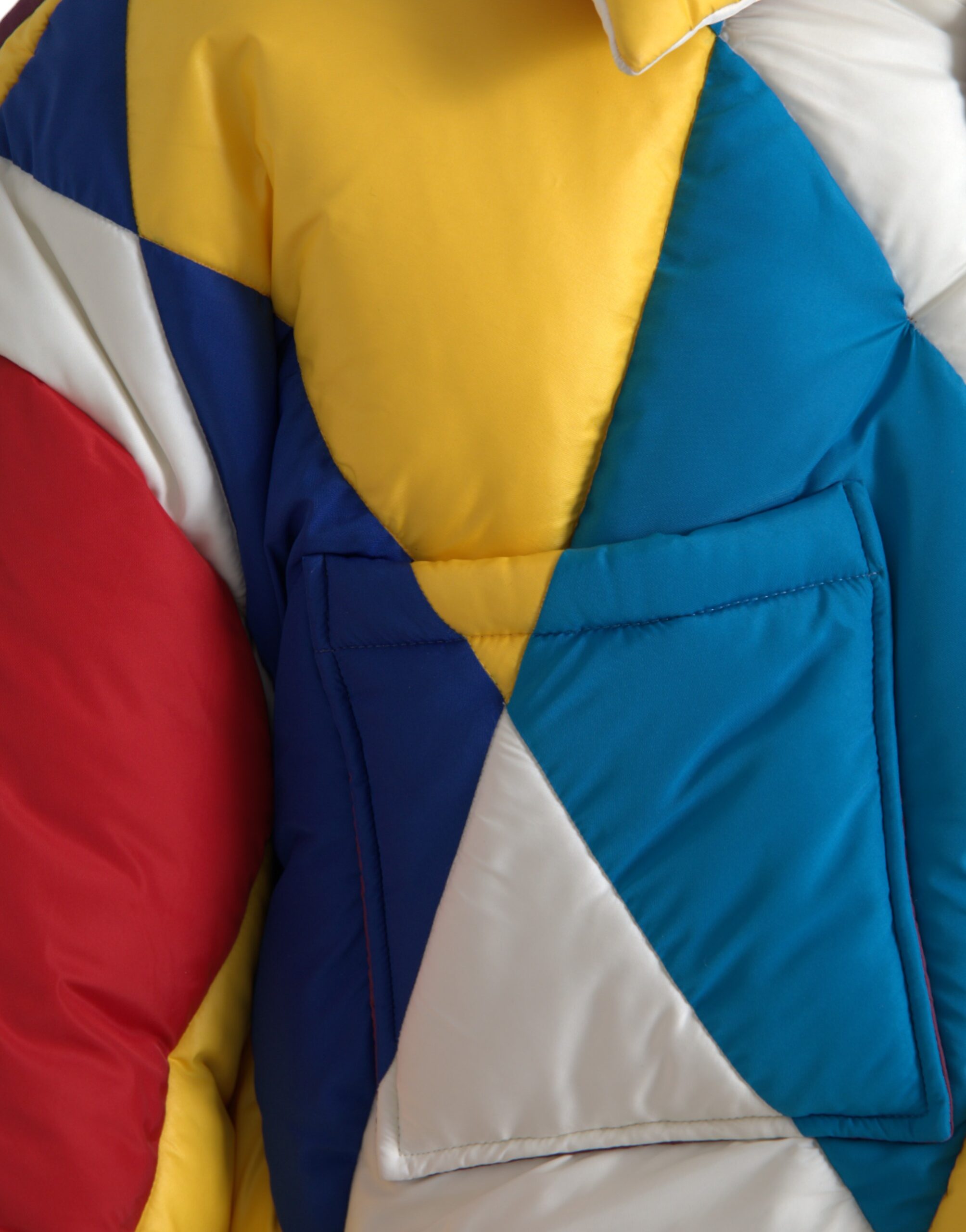 Multicolor Dolce & Gabbana men's puffer windbreaker jacket with a vibrant, quilted design and hood for stylish outdoor wear.