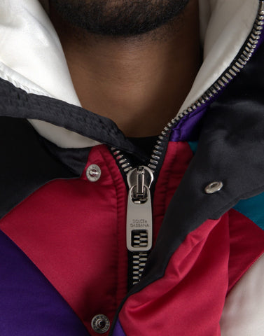 Multicolor logo Dolce & Gabbana windbreaker puffer jacket with vibrant design and lightweight, insulated material displayed in the image.