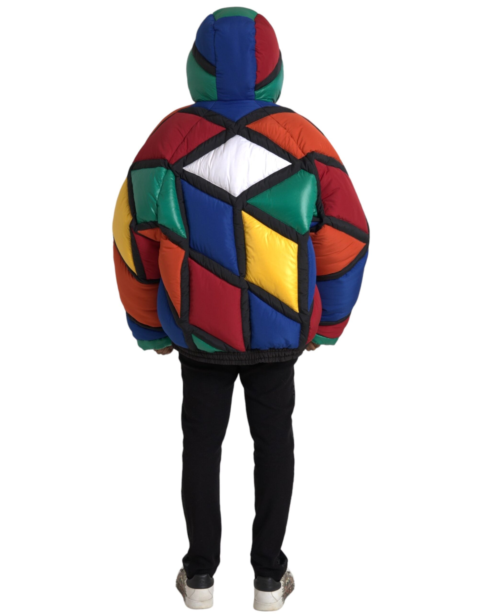 Multicolor quilted hooded puffer jacket by Dolce & Gabbana, featuring vibrant patchwork and a cozy hood, displayed on a hanger.