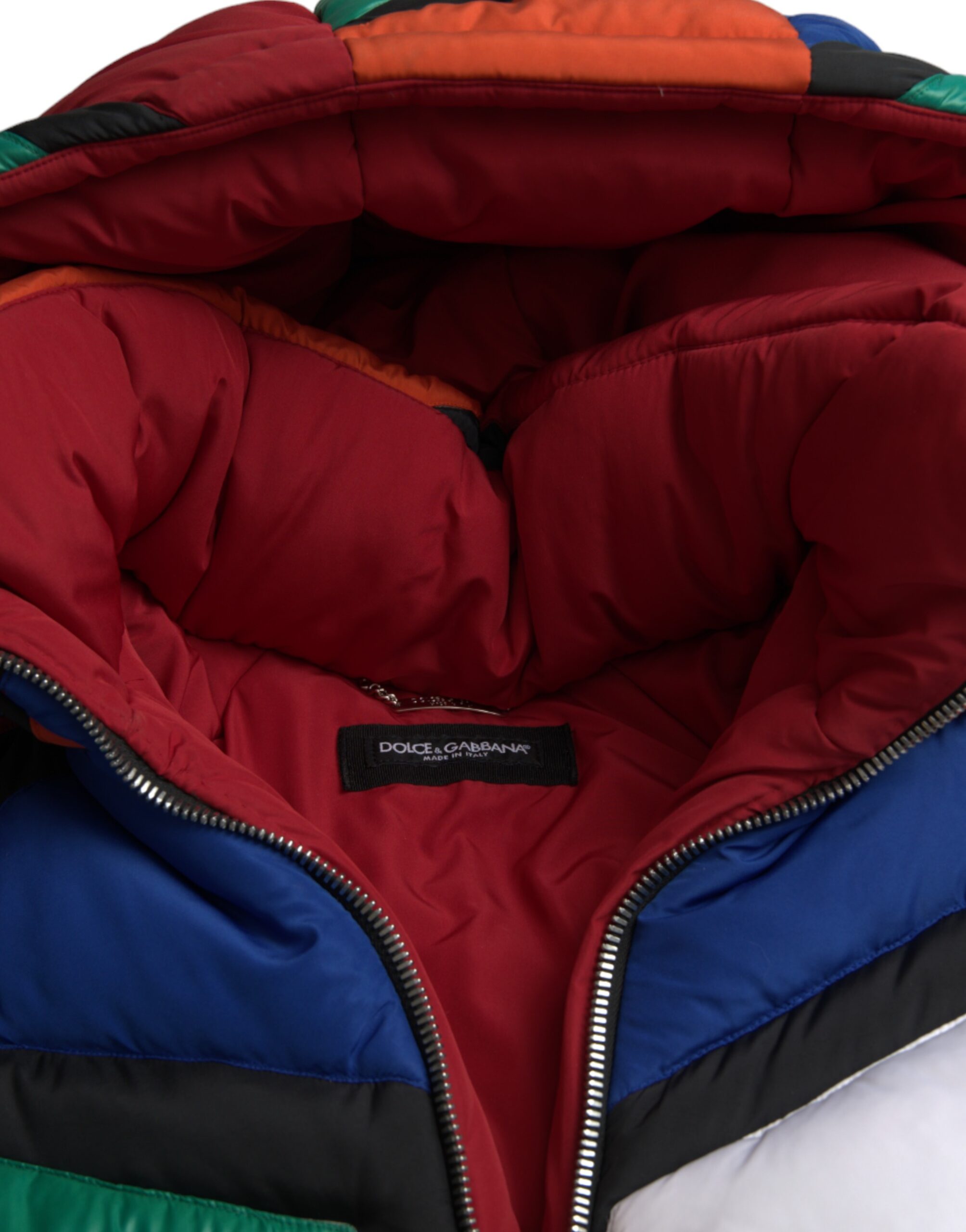 Multicolor quilted puffer jacket with hood by Dolce & Gabbana, showcasing vibrant patchwork design and padded texture.