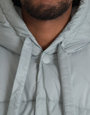 Light blue quilted hooded puffer jacket for men by Dolce & Gabbana, featuring a padded design and front zipper closure.