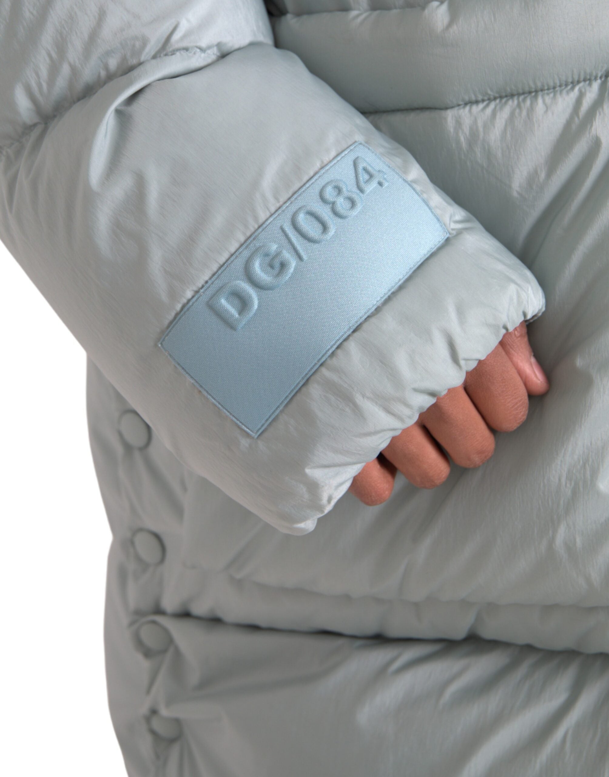 Light blue quilted hooded puffer jacket for men by Dolce & Gabbana, featuring a stylish quilted design and attached hood.
