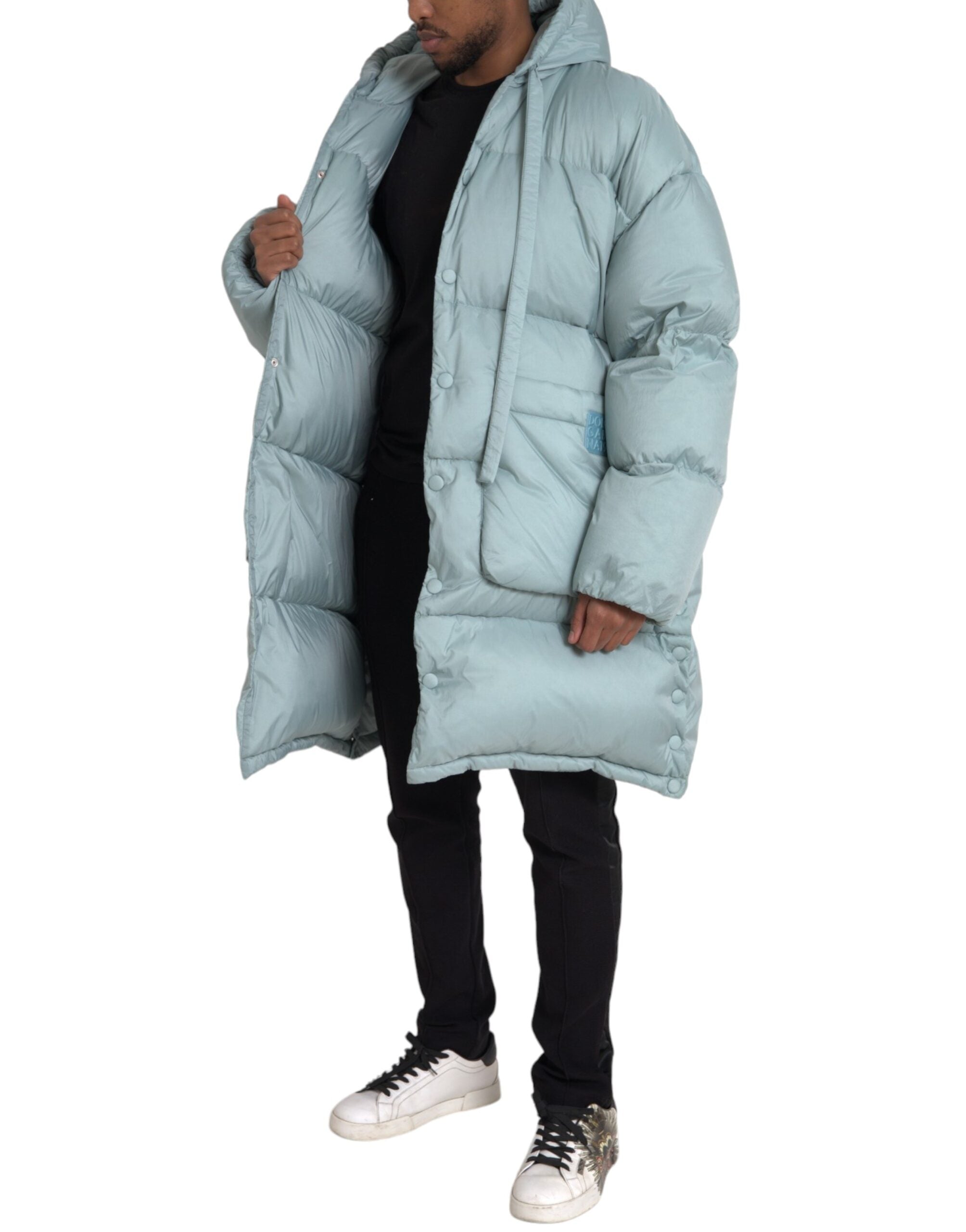 Light blue quilted hooded puffer jacket for men by Dolce & Gabbana, showcasing its stylish padded design and hooded collar.