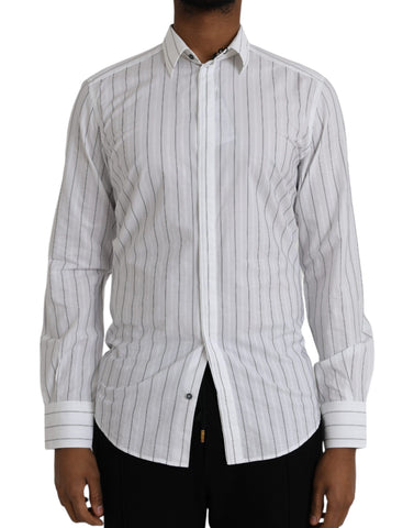 Black and white striped formal dress by Dolce & Gabbana, featuring a stylish gold shirt detail, shown on a model.