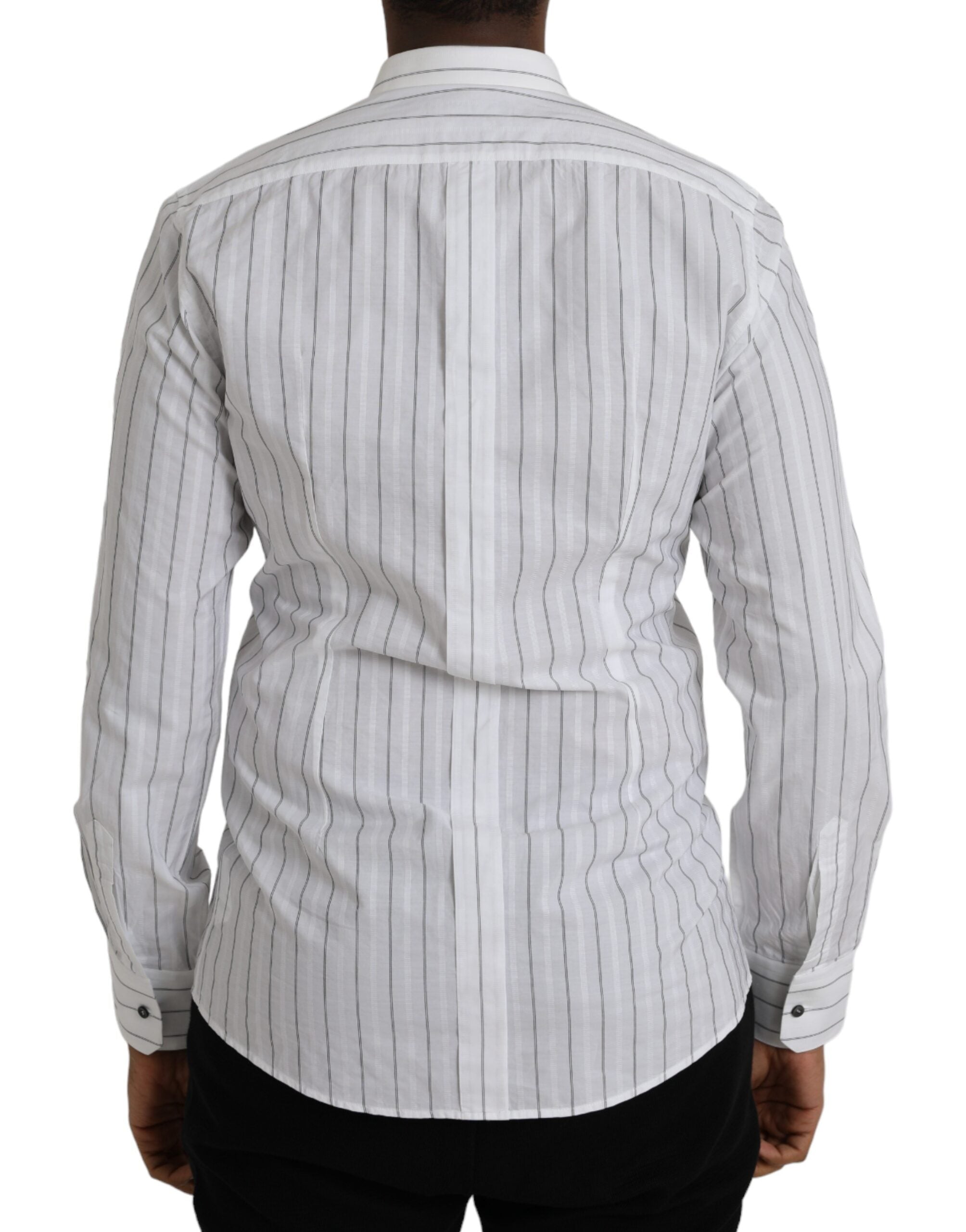 Black and white striped formal dress with gold accents by Dolce & Gabbana, shown on a mannequin.